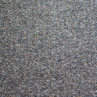 Fabric sample, gray-beige blend, granular texture with speckled surface and tight weave; “bolzan letti” label visible.